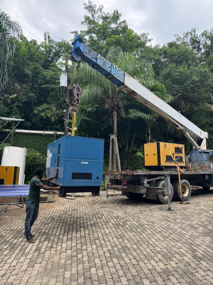 Crane lifting a generator into place on site