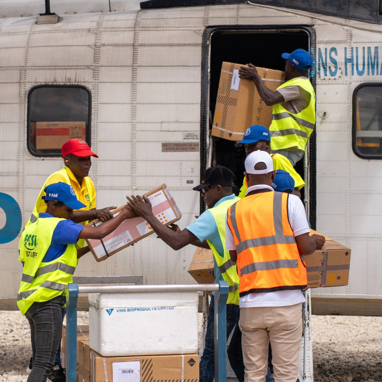 HCS staff helping load emergency medicine onto a UNHAS aircraft